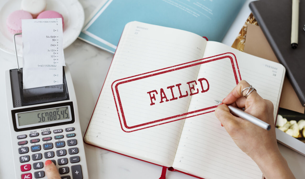Failed loan application concept with calculator, receipts, and notebook, representing why banks reject foreigner loans in Singapore and alternative licensed moneylender solutions.