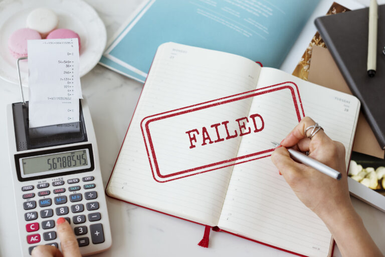 Failed loan application concept with calculator, receipts, and notebook, representing why banks reject foreigner loans in Singapore and alternative licensed moneylender solutions.