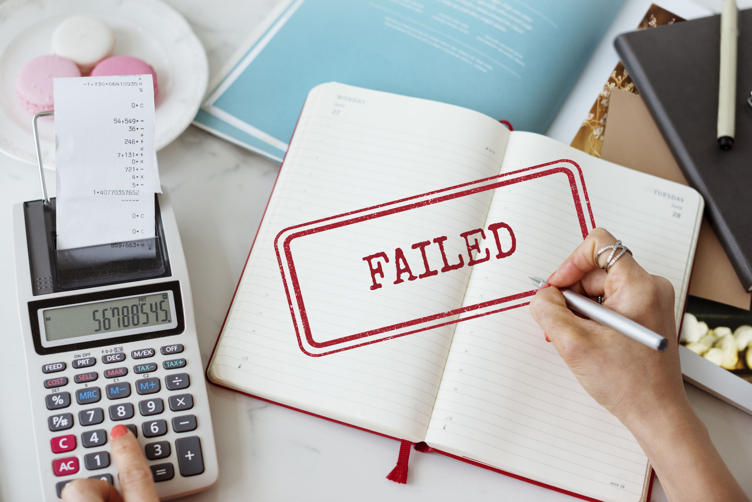 Failed loan application concept with calculator, receipts, and notebook, representing why banks reject foreigner loans in Singapore and alternative licensed moneylender solutions.