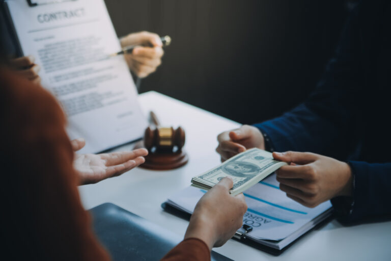 Customer receiving cash from a licensed moneylender during a loan agreement, representing legal lending services and common myths about licensed moneylenders.