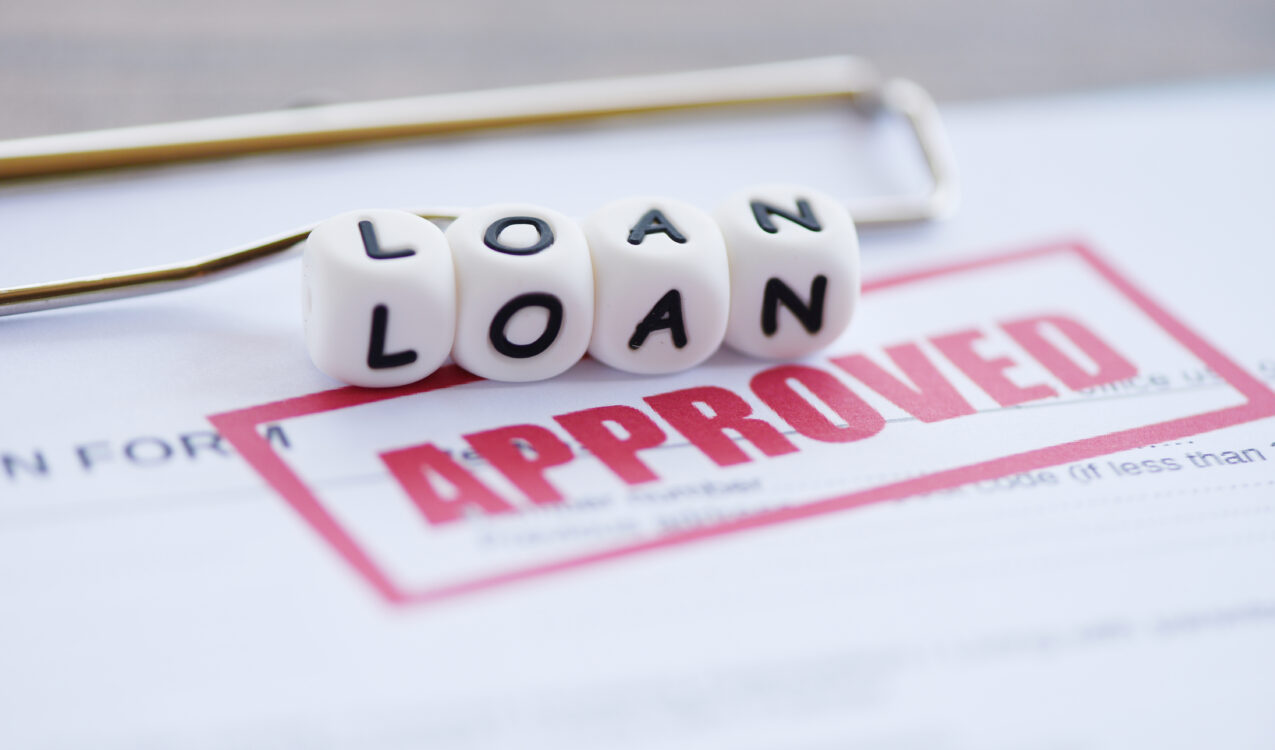 Loan approval document with "Approved" stamp and loan text blocks, representing fast loan approval and financing services from Khalon & Gill.